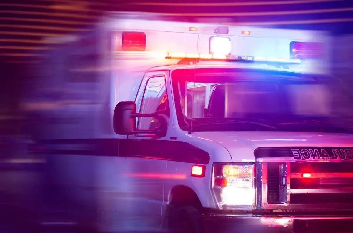 An ambulance with its emergency lights on